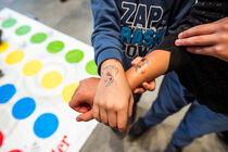 Zwei Kinder zeigen stolz ihre Kindertattoos auf dem Handrücken. 